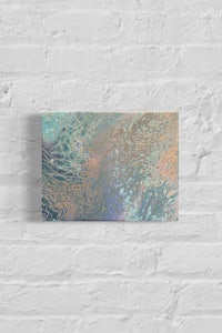 an abstract painting on a brick wall
