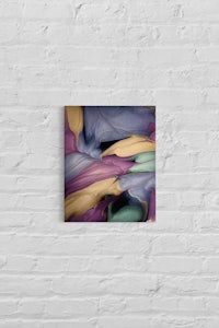 an abstract painting hanging on a brick wall