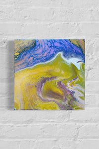 an abstract painting on a brick wall