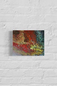 an abstract painting on a brick wall